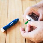 old-lady-is-testing-blood-sugar-level-using-blood-sugar-test-kid-set