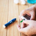 old-lady-is-testing-blood-sugar-level-using-blood-sugar-test-kid-set